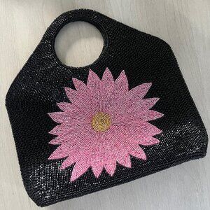 Black beaded handbag featuring a large pink and gold flower applique